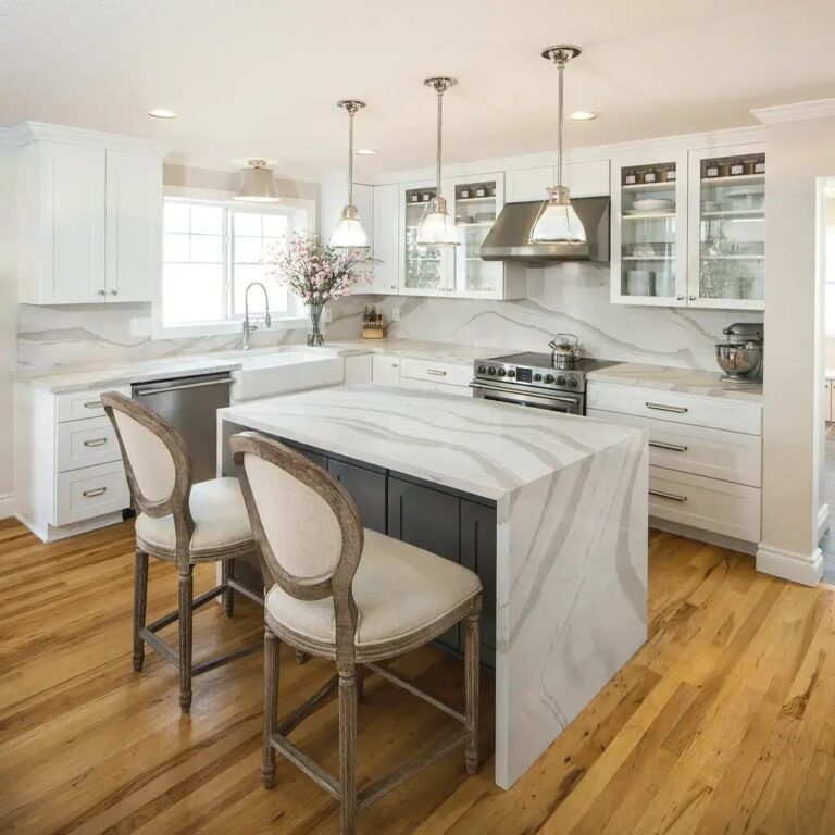 old oak flooring in a transitional kitchen with waterfall edge island counter in granite
