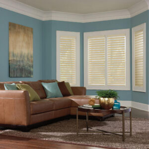 white wood blinds in a living room with light bue wall