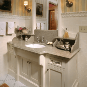 Traditional bathroom vanity with granite countertops on off-white cabinetry