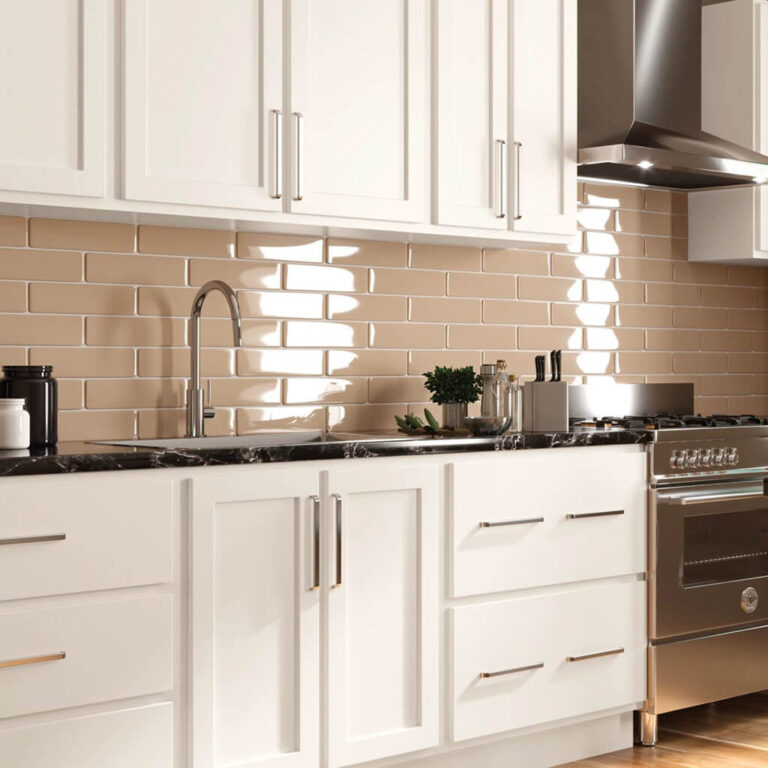 Mantra white kitchen cabinets with neutral colored subway tile backsplash