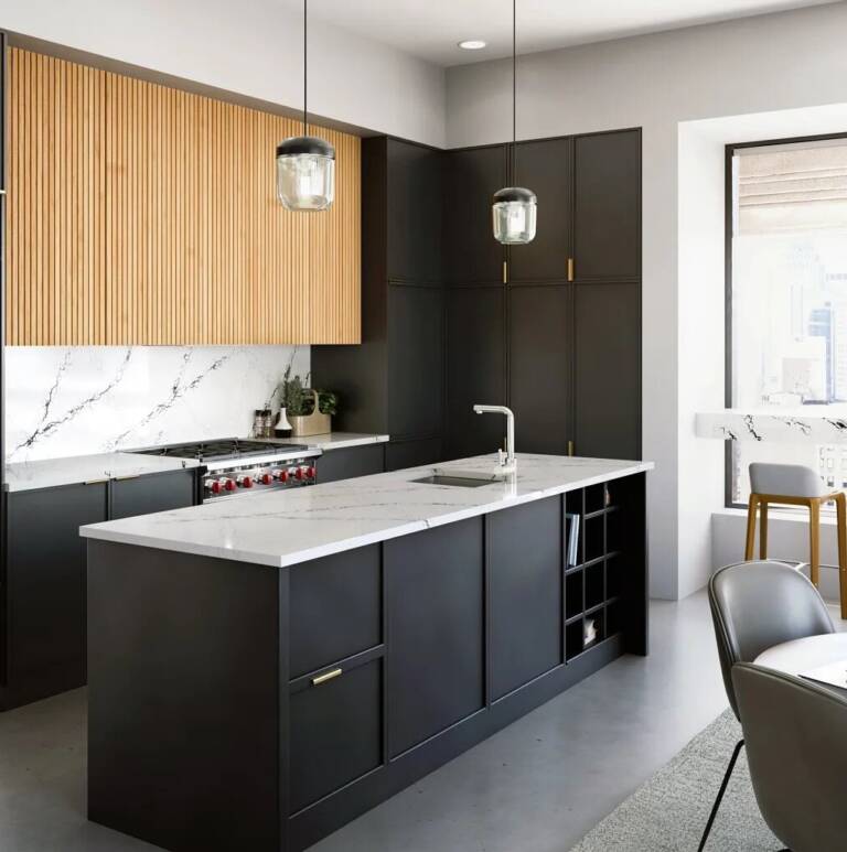 Modern kitchen in apartment with concrete floor and white stone surface counters