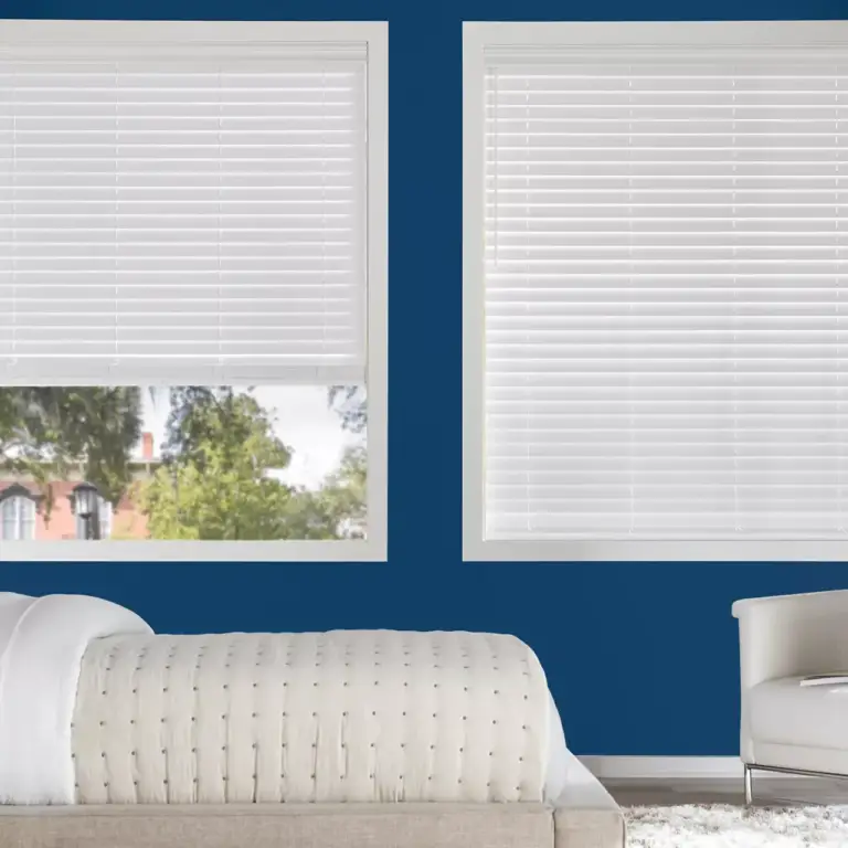 white hunter douglas blinds in a blue bedroom